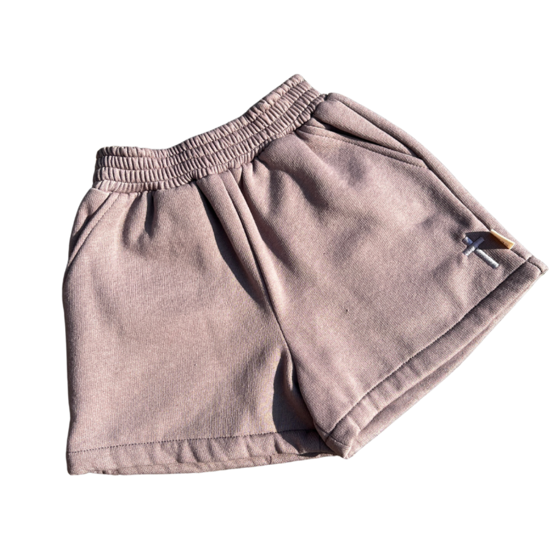 Pair of beige shorts on a white background