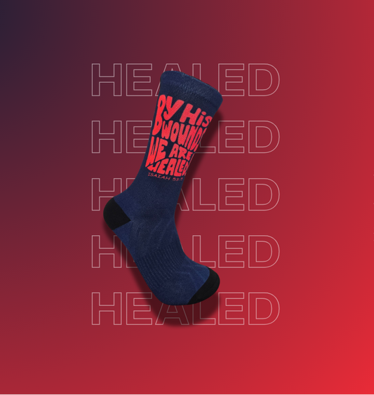 Navy crew socks with the text "By His wounds we are healed" in red.