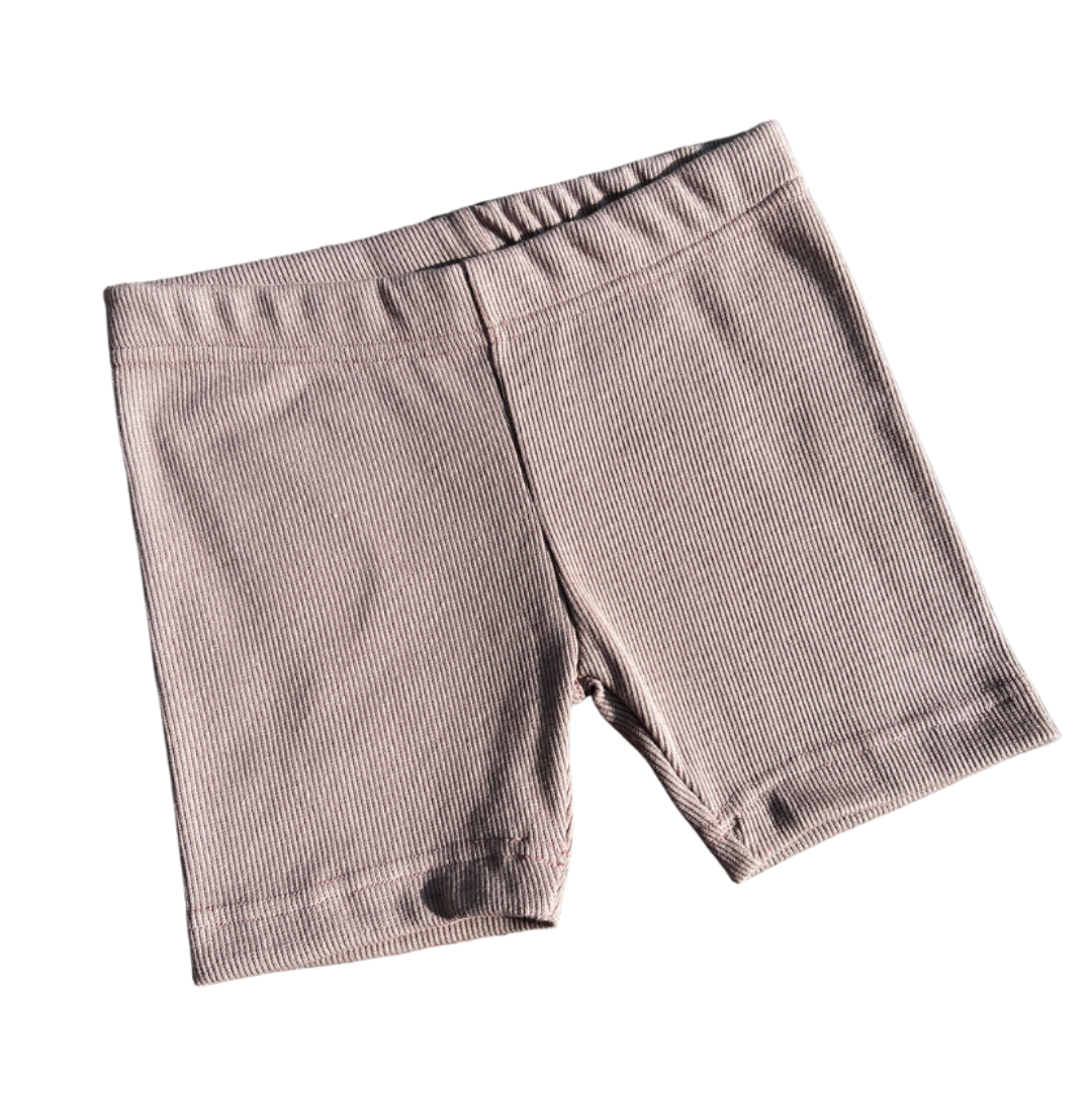 Pair of dusty pink shorts on a white background