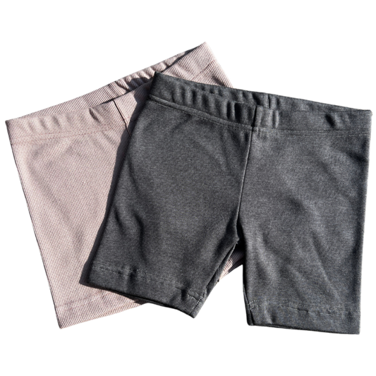 Two pairs of Leggings one gray and one Dusty pink, on a white background