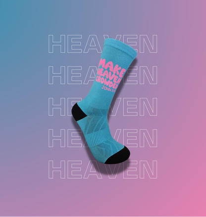 A single light blue crew sock with black toe and heel accents, featuring pink text that reads 'MAKE HEAVEN crowded', shown on a pink-to-blue gradient background with repeated faint 'HEAVEN' text.